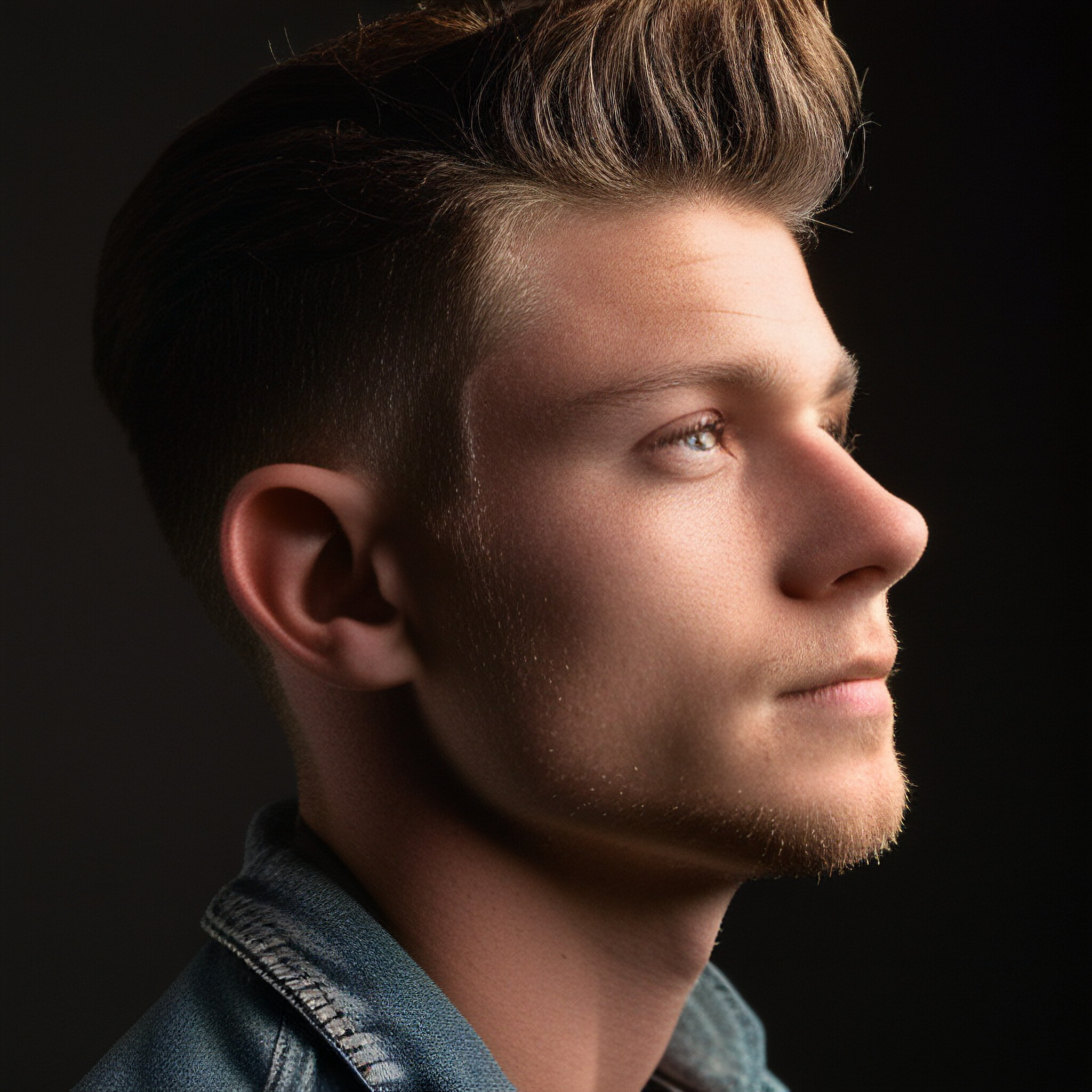 Get ready to be inspired by this stunning close-up of a low fade hairstyle. The way the shorter hair on one side seamlessly blends into the longer strands at the top and back is a testament to the skill and precision involved in crafting this popular trend.